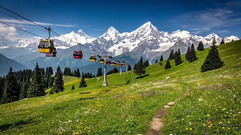 Gulmarg meadow with gondola cable cars and snow-capped Himalayan peaks